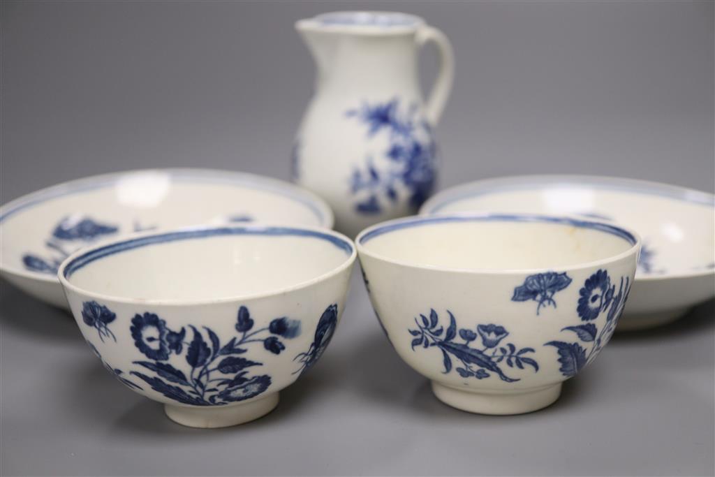 A group of Worcester Three Flowers tea wares, c.1775, comprising two tea bowls and saucers and a sparrow beak milk jug